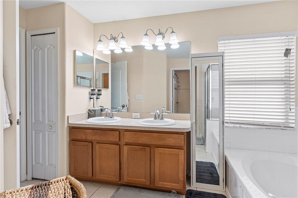4667 Hickory Stream Lane Mulberry, FL 33860 - Photo 18 of 41 a bathroom with a sink double vanity granite tub and shower