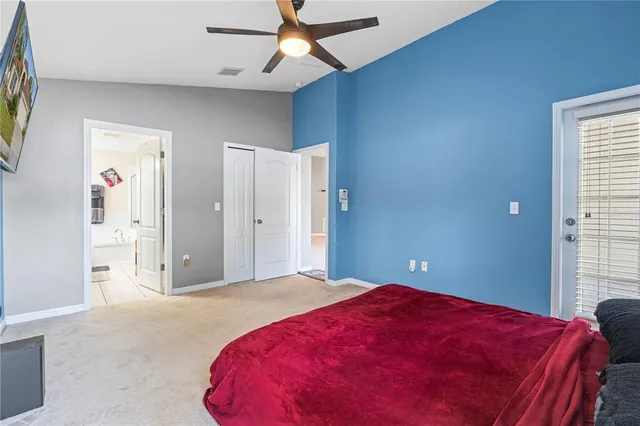 a bedroom with a large bed and a chandelier