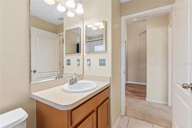 a bathroom with a sink a light fixture and a mirror