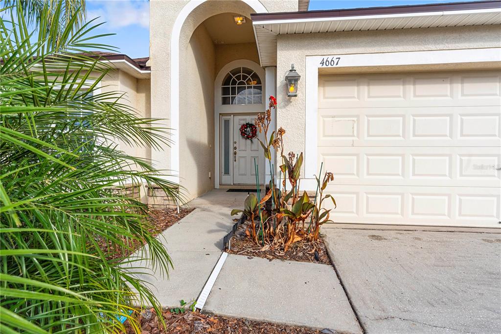 4667 Hickory Stream Lane Mulberry, FL 33860 - Photo 4 of 41 a front view of a house with outdoor seating