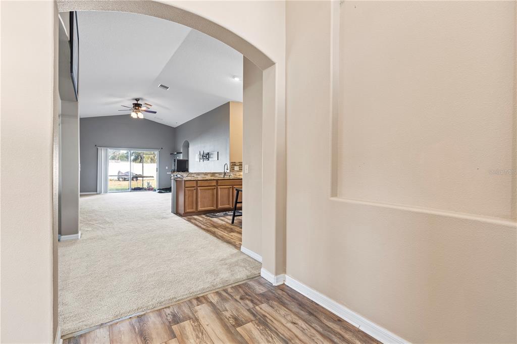 4667 Hickory Stream Lane Mulberry, FL 33860 - Photo 6 of 41 a view of a hallway with wooden floor and furniture