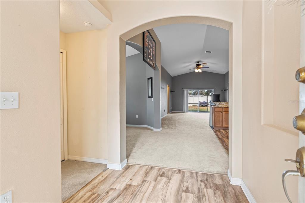 4667 Hickory Stream Lane Mulberry, FL 33860 - Photo 7 of 41 a view of a kitchen from the hallway