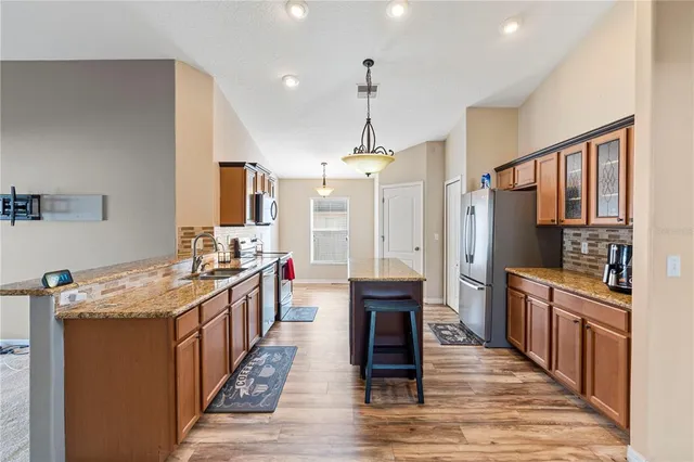 a kitchen with stainless steel appliances granite countertop a stove oven and a refrigerator