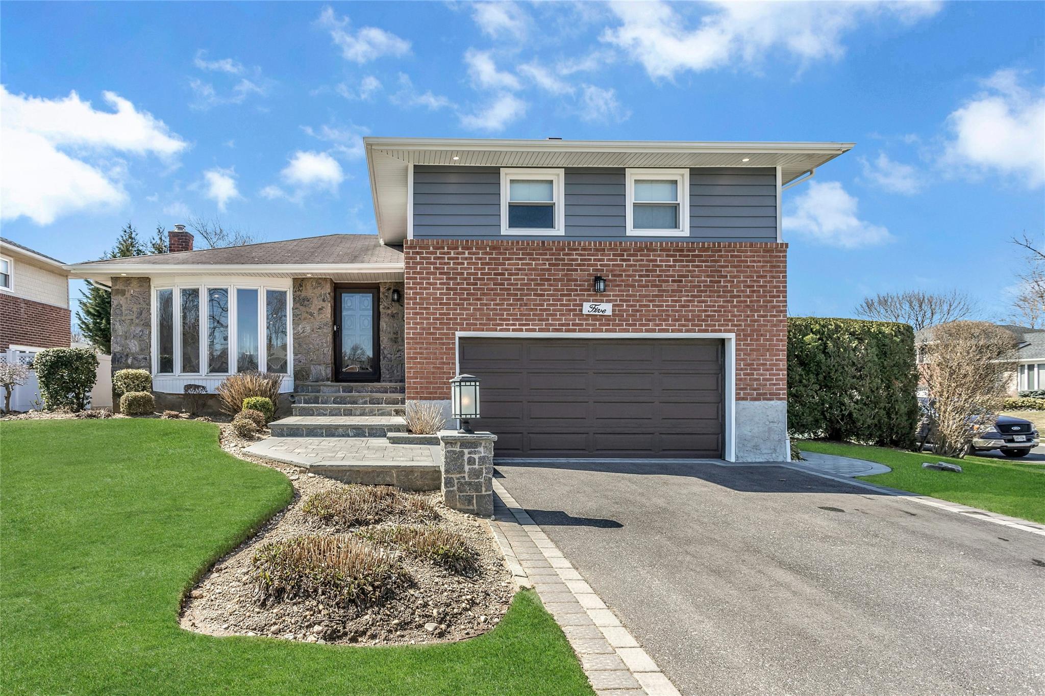 5 Myron Road Plainview, NY 11803 - Photo 1 of 1 Front view of property on a professionally landscaped property