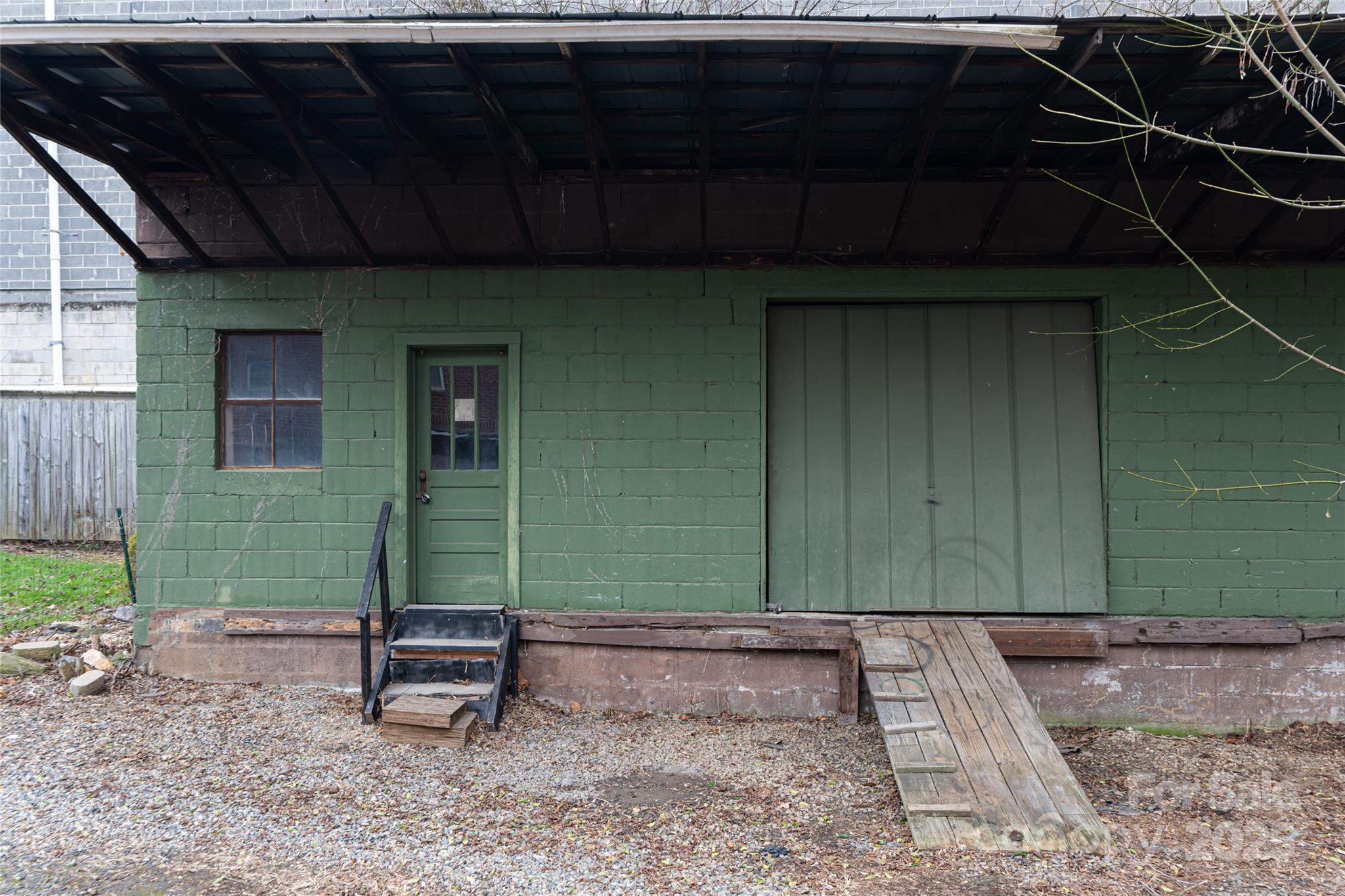 714.5 Reed Street Asheville, NC 28803 - Photo 24 of 26 a backyard of a house with plants and wooden fence