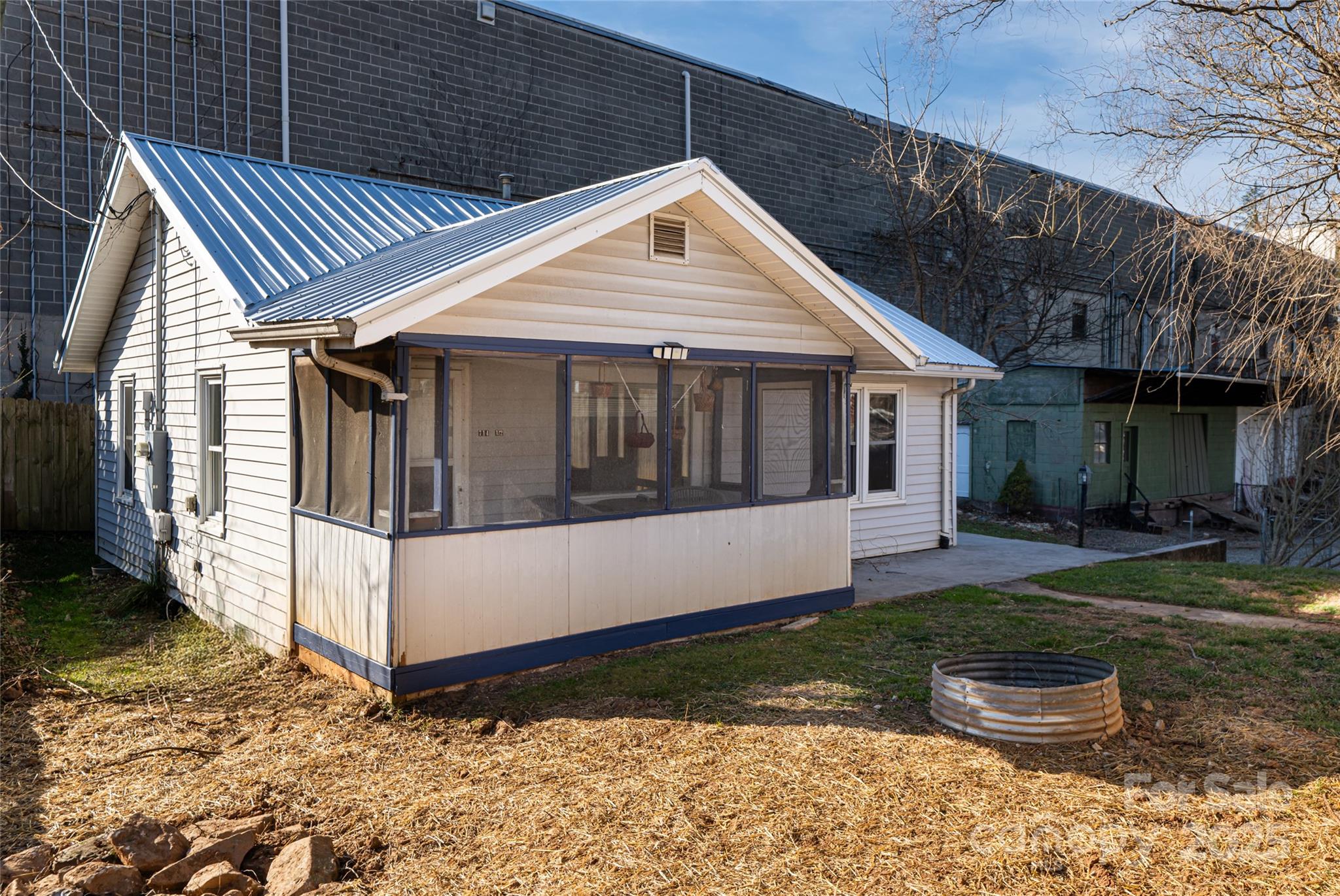 714.5 Reed Street Asheville, NC 28803 - Photo 26 of 26 a view of a white house next to a yard with potted plants