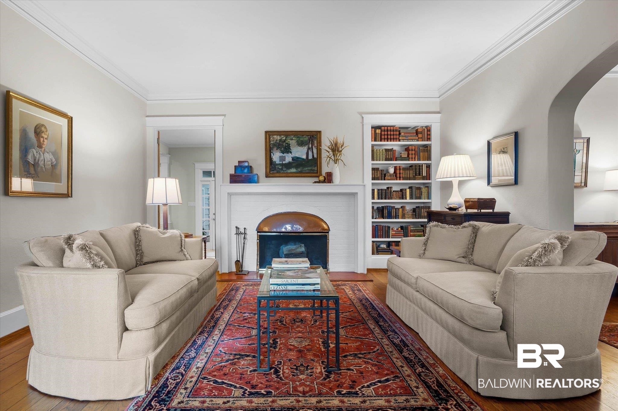 2 Westgate Road Mobile, AL 36608 - Photo 7 of 63 Living room with arched walkways, hardwood / wood-style floors, ornamental molding, and a brick fireplace