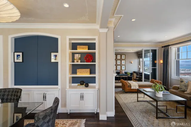 a living room with furniture and a book shelf