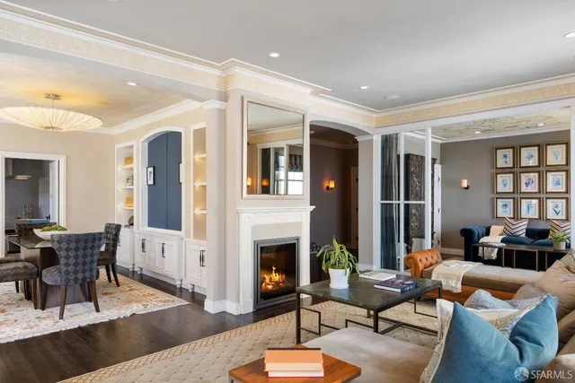 a living room with furniture fireplace and a table