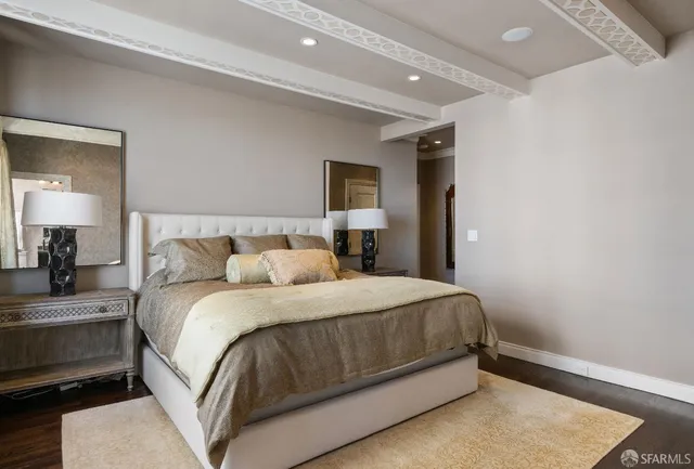 a bedroom with a bed and a night stand