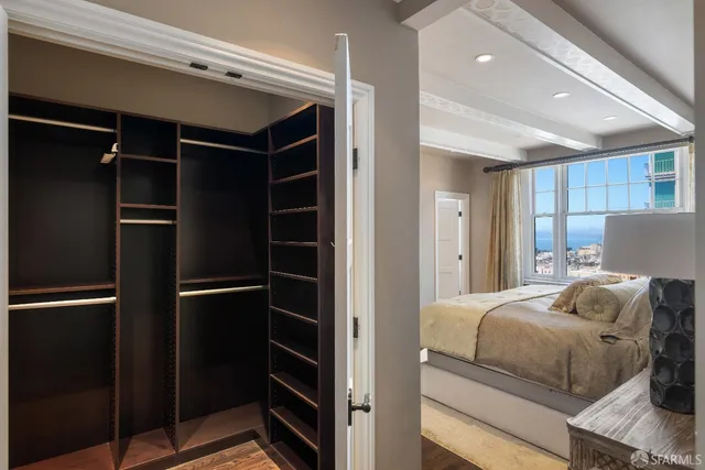 a bedroom with a bed and a walk in closet