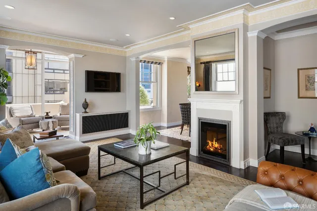 a living room with furniture a fireplace and a flat screen tv