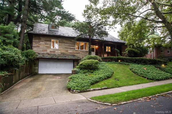 a front view of a house with a garden