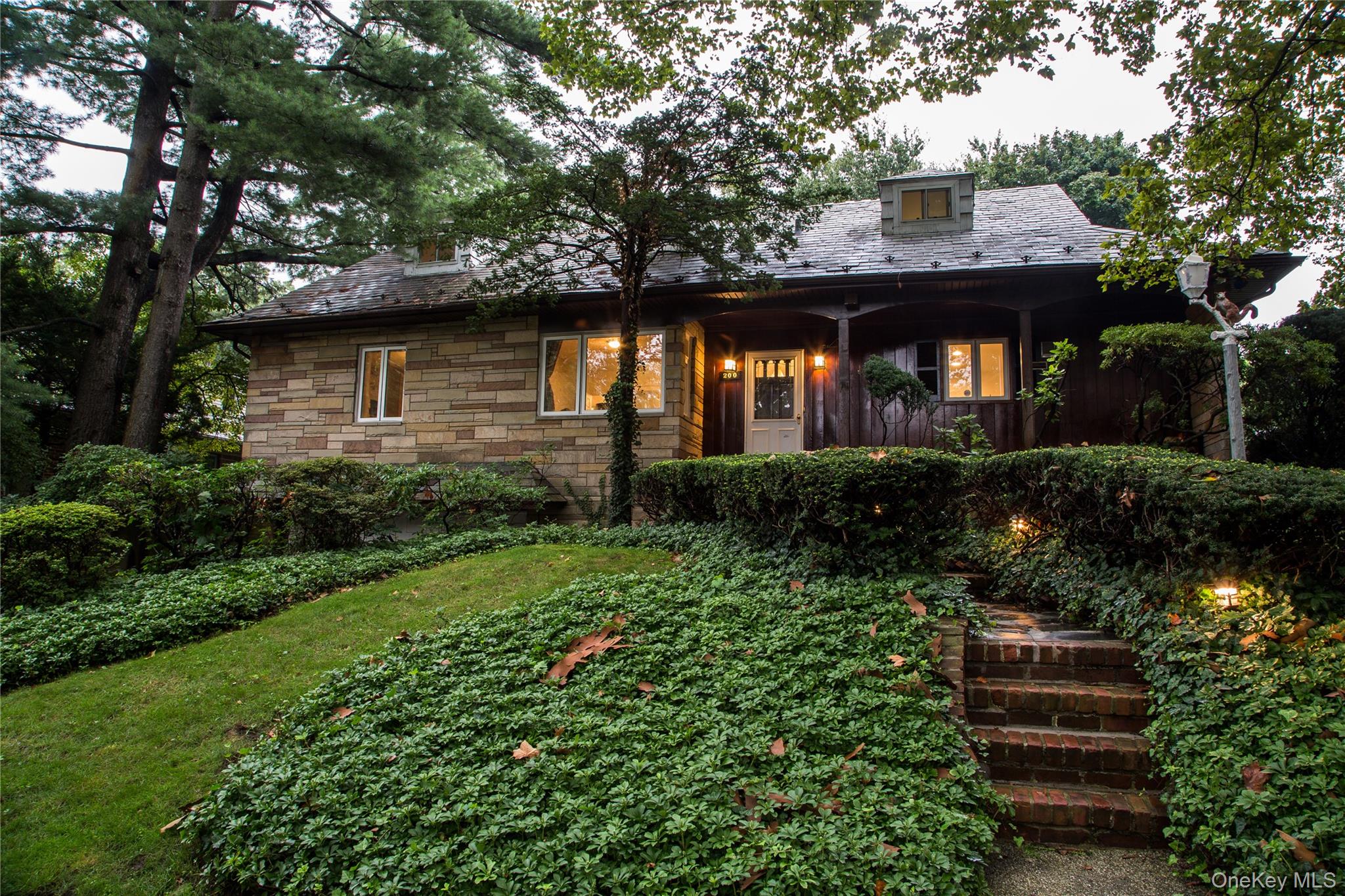 200 Melbourne Road Great Neck, NY 11021 - Photo 2 of 24 a front view of a house with a garden