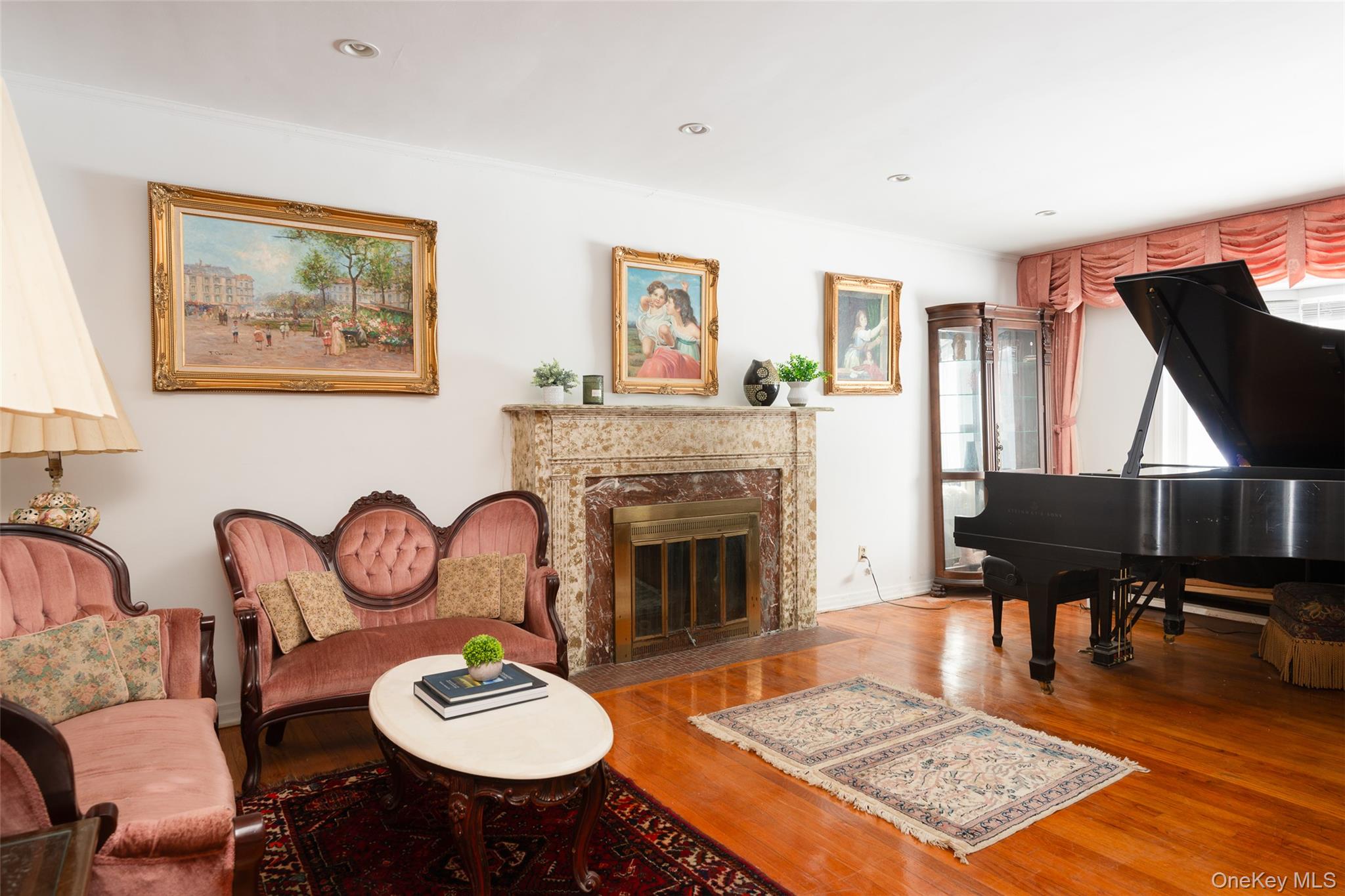200 Melbourne Road Great Neck, NY 11021 - Photo 4 of 24 a living room with furniture a rug and a fireplace