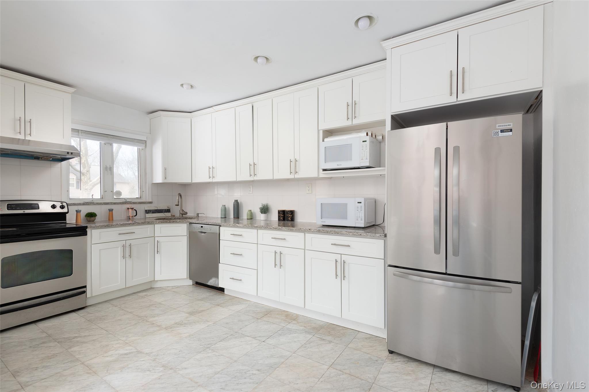 200 Melbourne Road Great Neck, NY 11021 - Photo 7 of 24 a kitchen with cabinets stainless steel appliances and a window