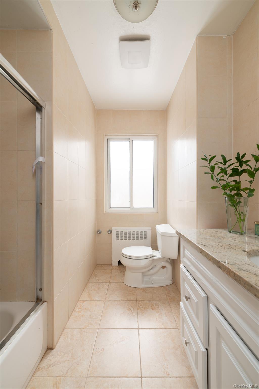 200 Melbourne Road Great Neck, NY 11021 - Photo 10 of 24 a spacious bathroom with a granite countertop sink a toilet and shower