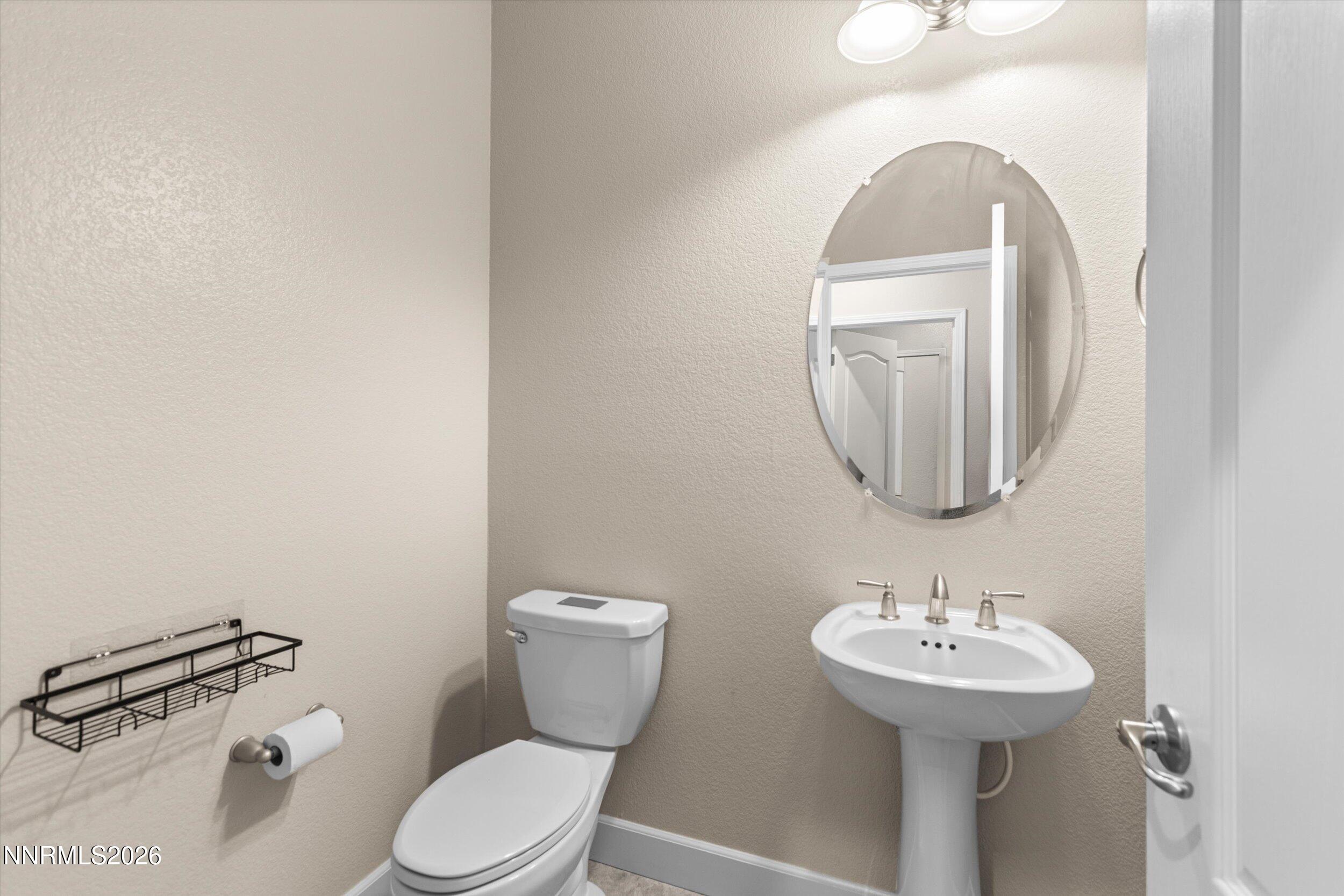 1725 Verdi Vista Court Reno, NV 89523 - Photo 13 of 37 a bathroom with a toilet sink and mirror