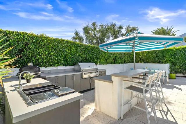 a living room with furniture large windows and a flat screen tv
