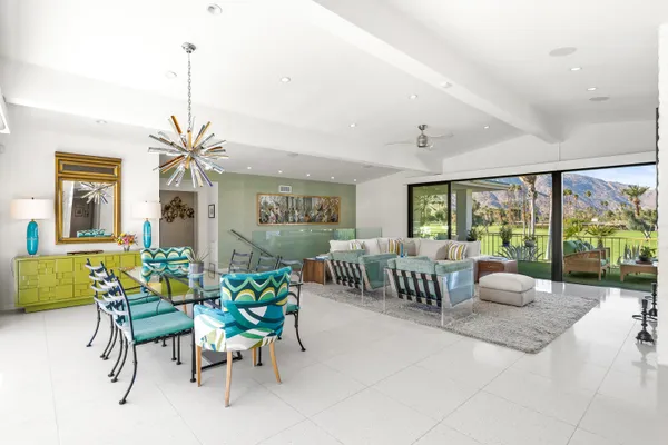 a view of a patio with couches chairs potted plants and a big yard