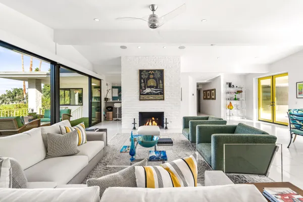 a view of a chair and tables in the back yard