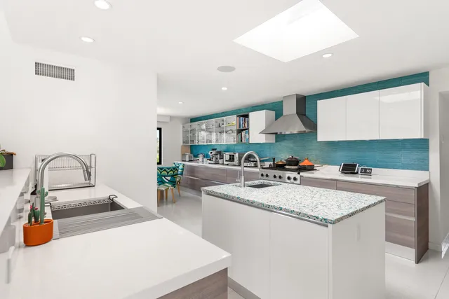 a spacious bathroom with a double vanity sink mirror and bathtub