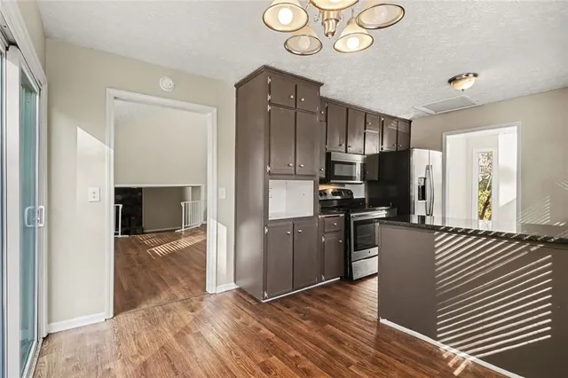 a kitchen with wooden cabinets and stainless steel appliances