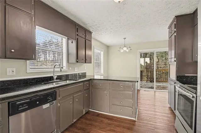 a kitchen with a sink stove and cabinets