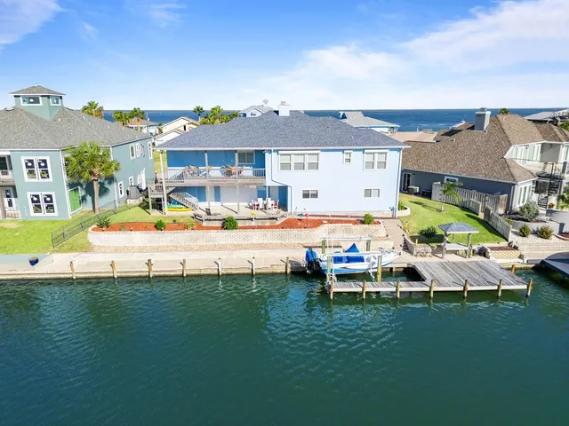 a living room with furniture a fireplace and a ceiling fan