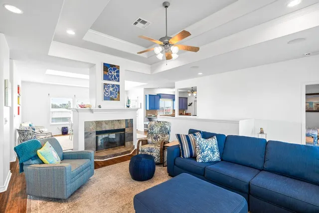a living room with furniture a fireplace and a flat screen tv