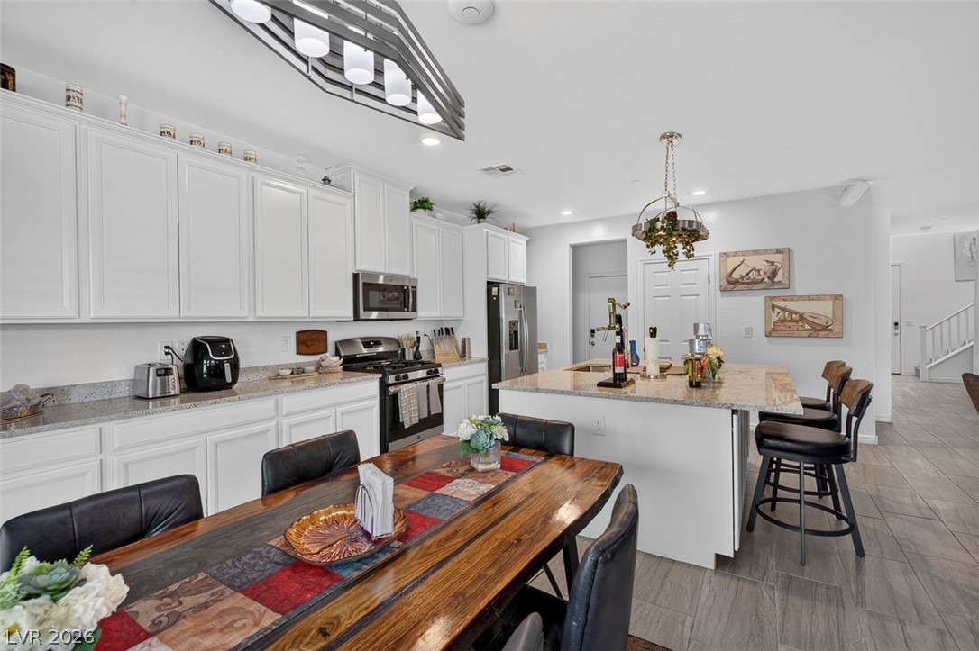 1824 Redland Ridge Street Henderson, NV 89002 - Photo 16 of 69 Culinary delights await in this bright kitchen with an inviting island and elegant granite countertops.