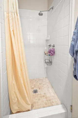 a en suite bathroom with a sink window and mirror