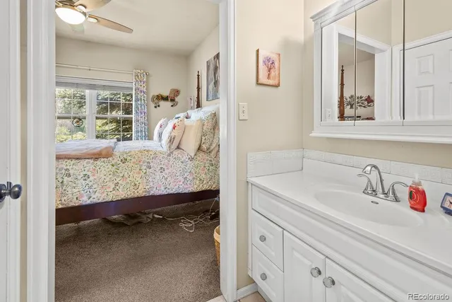 a bathroom with a sink toilet and a mirror