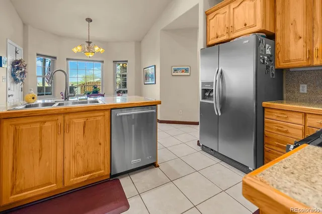 a kitchen with stainless steel appliances granite countertop a refrigerator and a stove