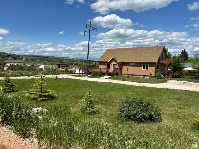 12 Crook Street Fish Haven, ID 83287 - Photo 8 of 35 View of front of house featuring a front lawn and a shingled roof