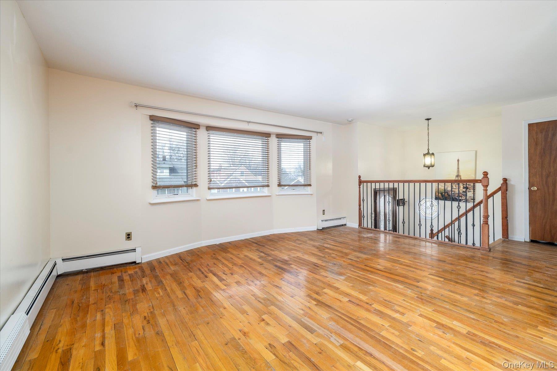 112 Chestnut Street Lynbrook, NY 11563 - Photo 12 of 13 a bedroom with a bed and a window