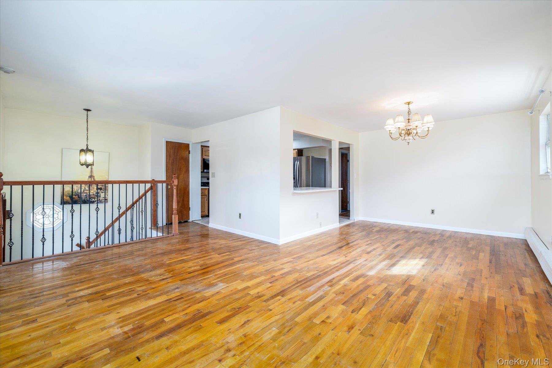 112 Chestnut Street Lynbrook, NY 11563 - Photo 4 of 13 a view of a livingroom with wooden floor and chandelier