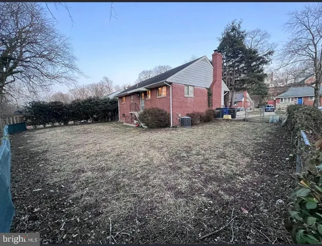 a view of a house with a yard covered in snow