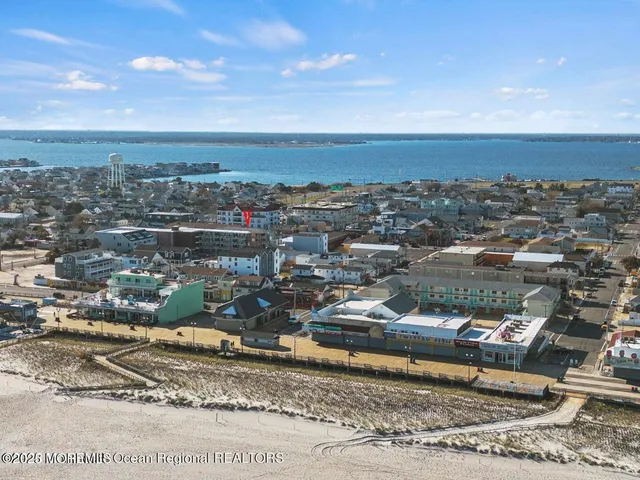 an aerial view of a residential houses with city view