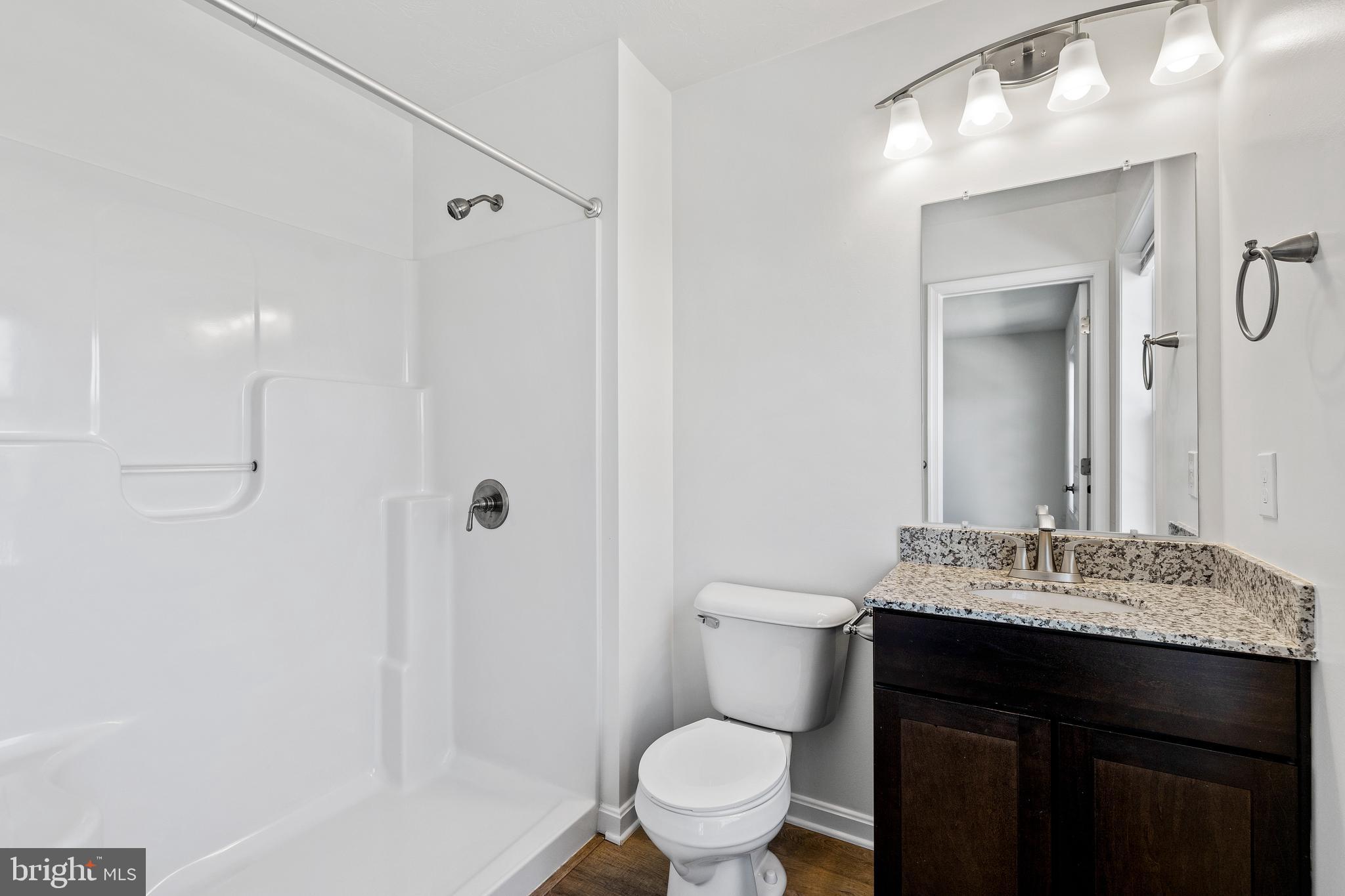 0 H Street, Unit 111 Carlisle, PA 17013 - Photo 22 of 26 a bathroom with a sink vanity mirror and toilet