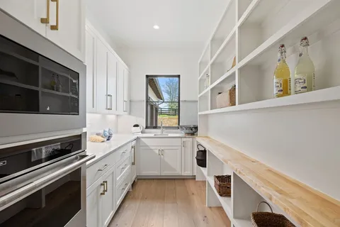 a living room with furniture and floor to ceiling windows