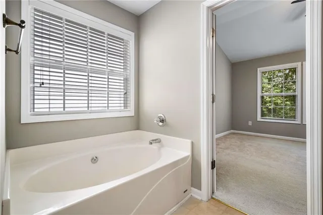 a white bath tub sitting next to a window