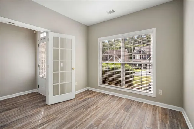 a view of wooden floor and windows in a room