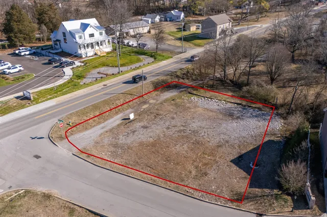 a view of a swimming pool with a yard and sitting area