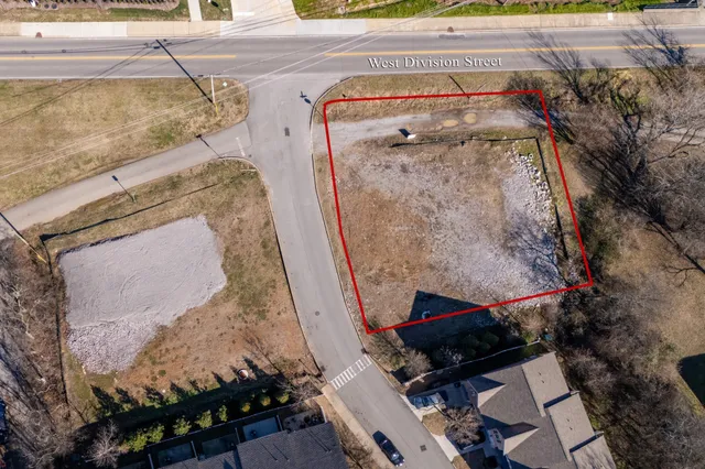 a view of a house next to a yard