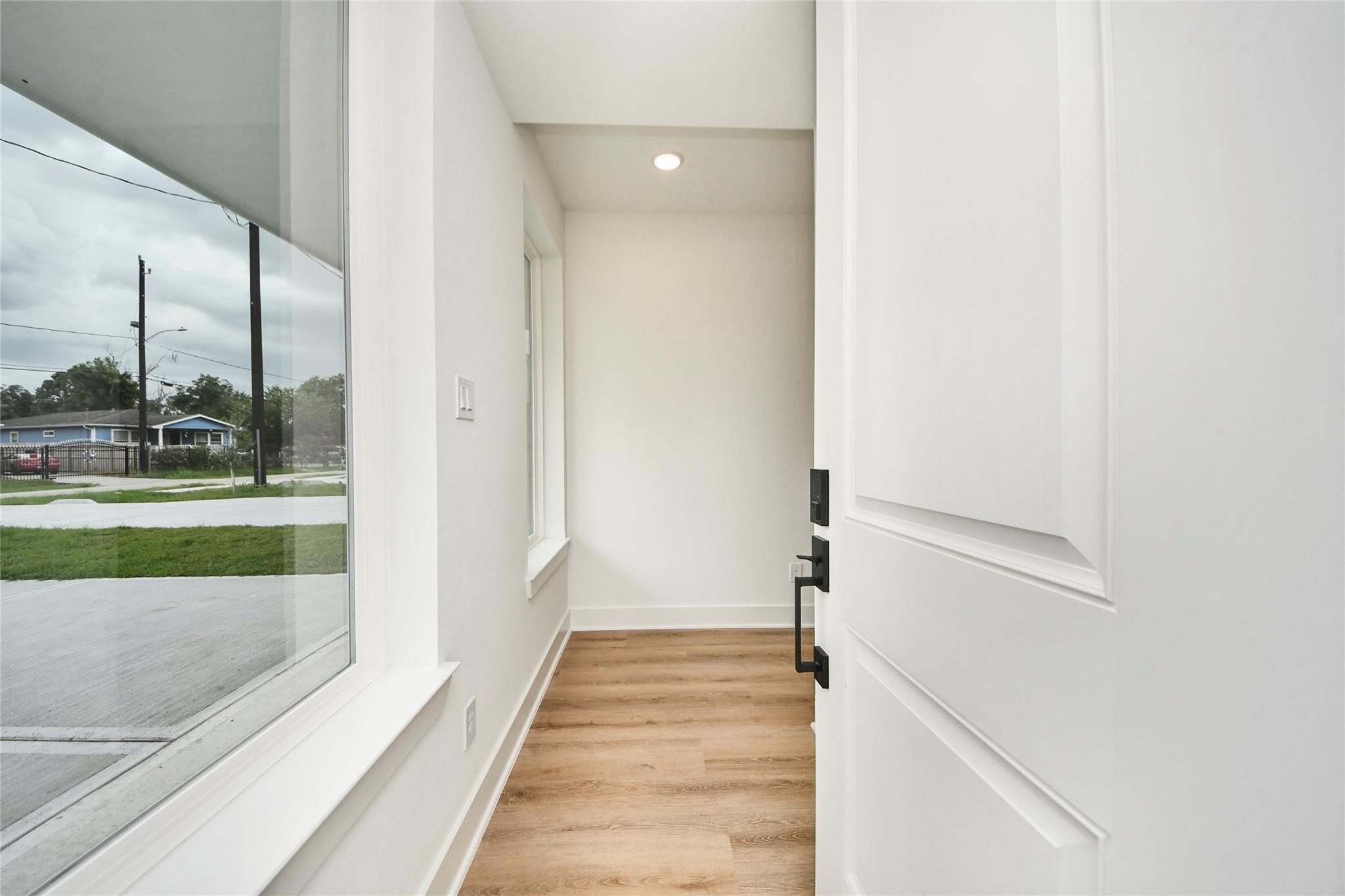 932 South Lane, Unit B Houston, TX 77088 - Photo 7 of 14 a view of a hallway with wooden floor and entryway