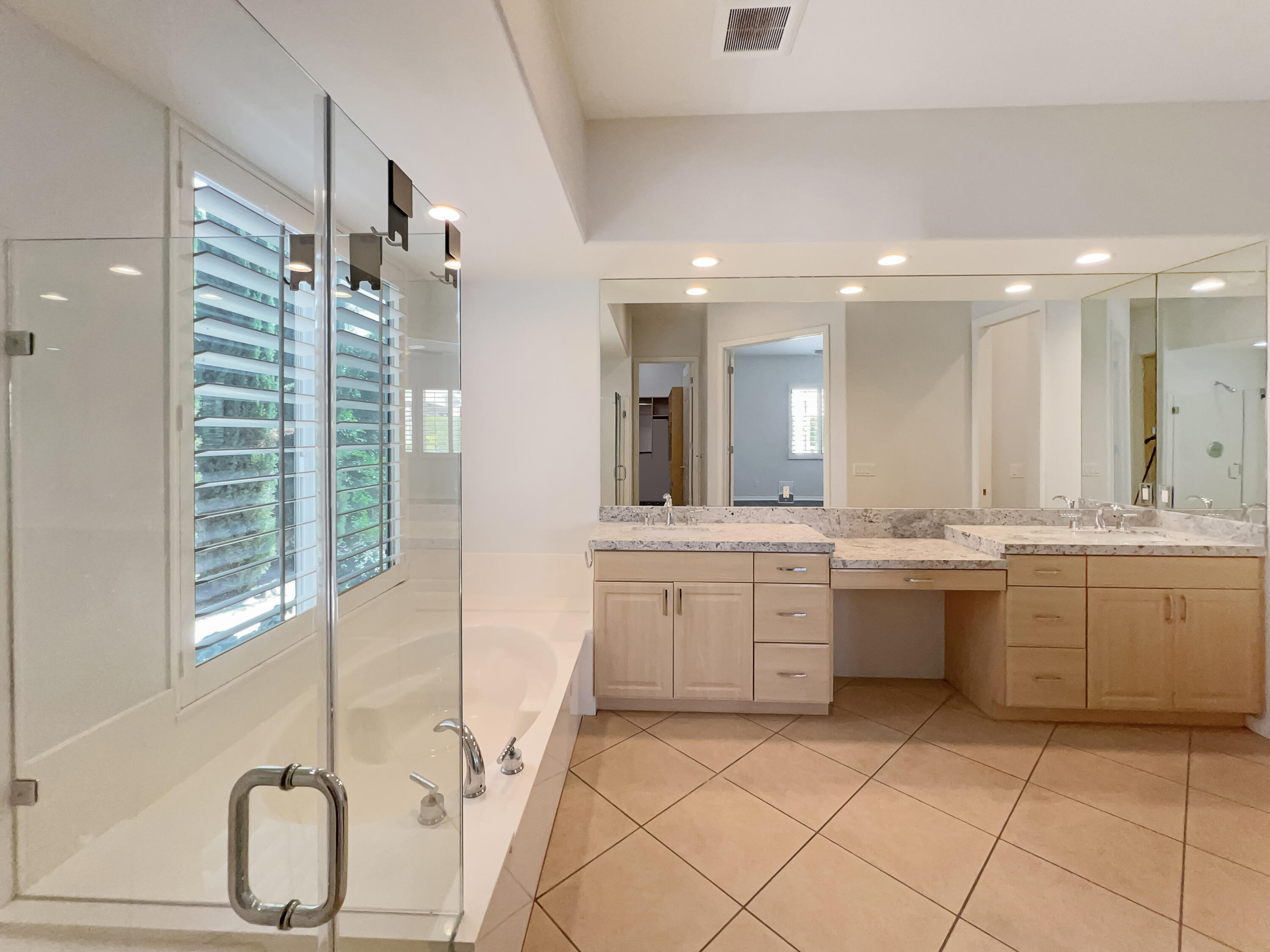 5 Lyon Road Rancho Mirage, CA 92270 - Photo 14 of 36 a large bathroom with a large tub sink and glass door