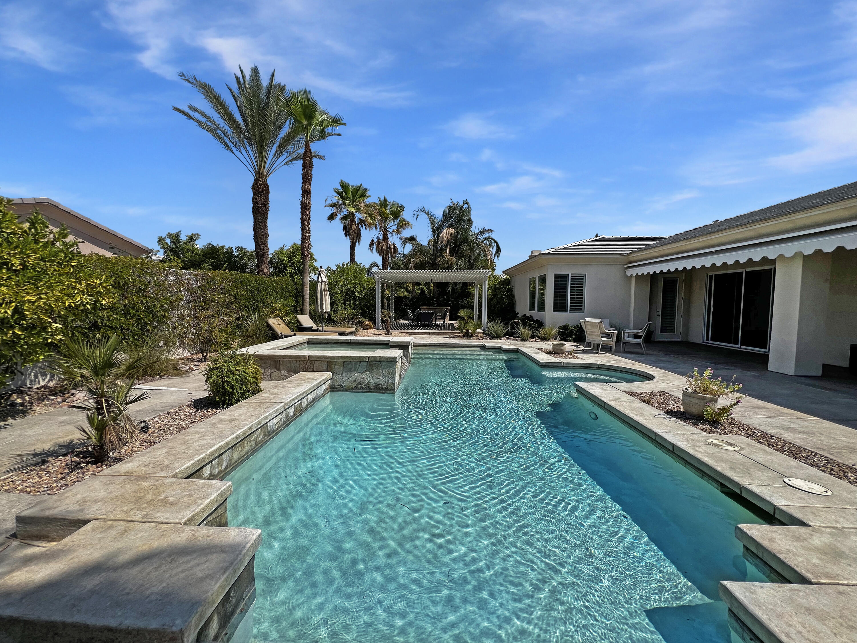 5 Lyon Road Rancho Mirage, CA 92270 - Photo 25 of 36 a view of a house with backyard outdoor seating area and furniture