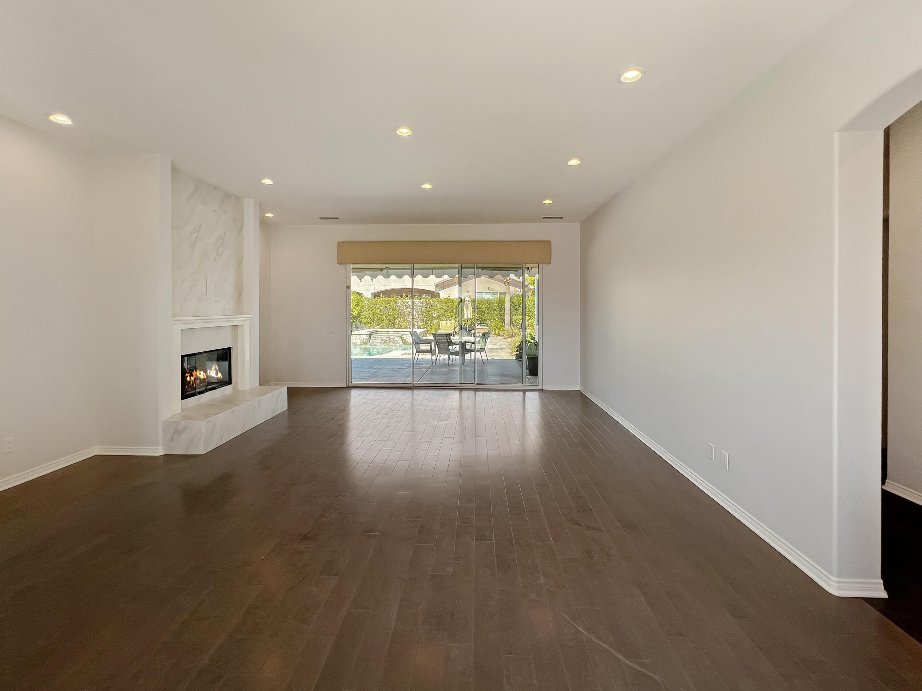 5 Lyon Road Rancho Mirage, CA 92270 - Photo 5 of 36 an empty room with wooden floor and windows