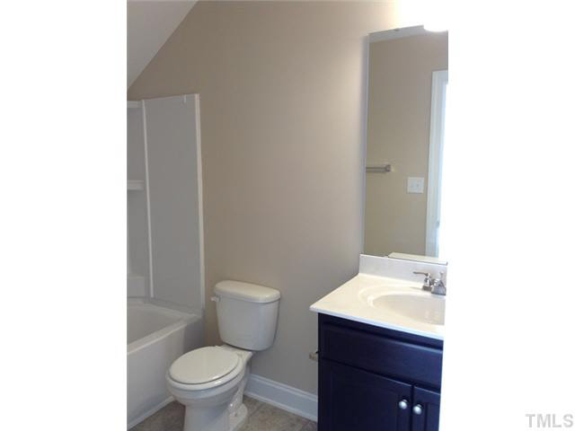 3513 Eastern Branch Road Raleigh, NC 27610 - Photo 14 of 14 a bathroom with a sink toilet and a mirror